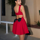 Women's red mini dress with V-neck and large back bow.